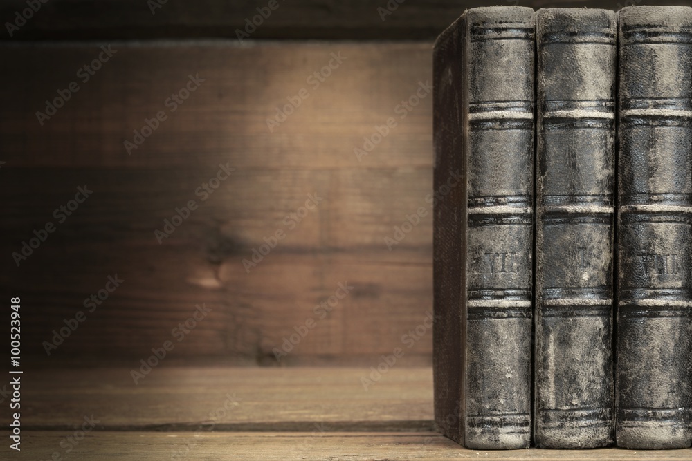 Fototapeta premium Three Old Shabby Books With Black Leather Cover Horizontal Backg