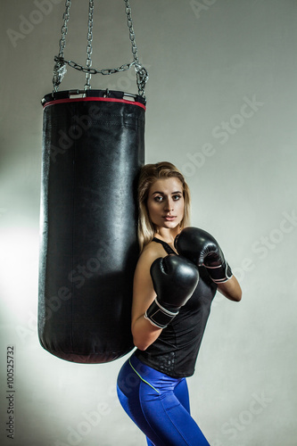 Sexy woman boxer near the boxing bag. © diter