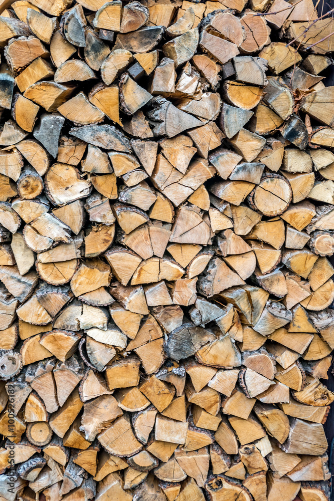 Chopped wood log stored as wall for winter Chopped wood log stored as wall for winter