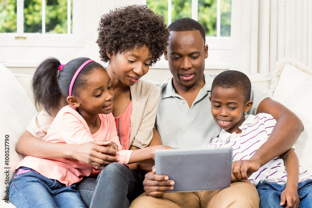 Happy family using tablet on the sofa Happy family using tablet on the sofa