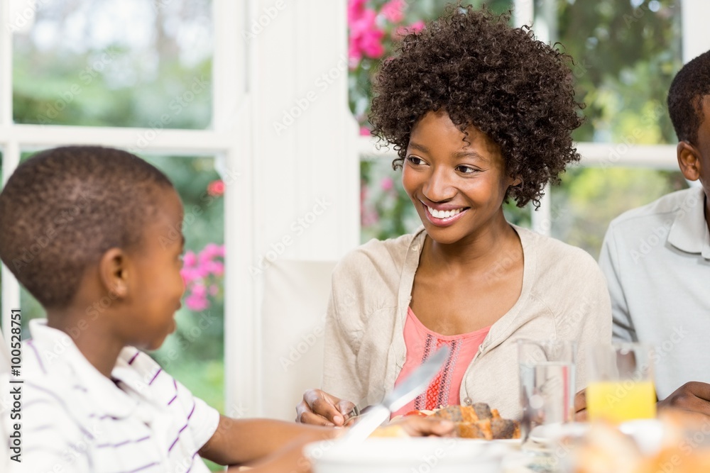 Smiling son eating his dinner Smiling son eating his dinner