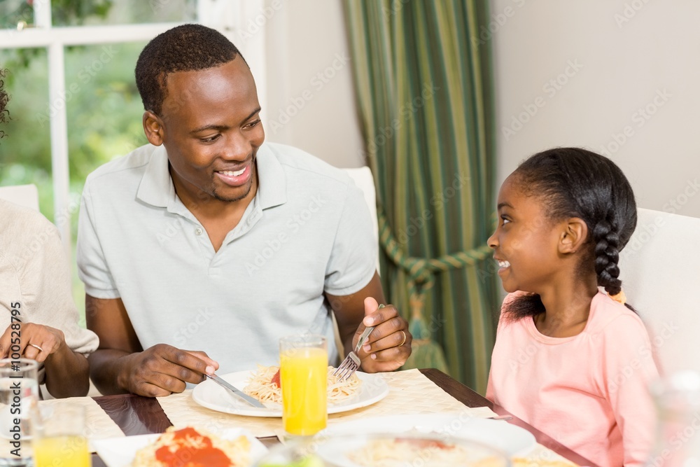 Happy family enjoying their meal Happy family enjoying their meal