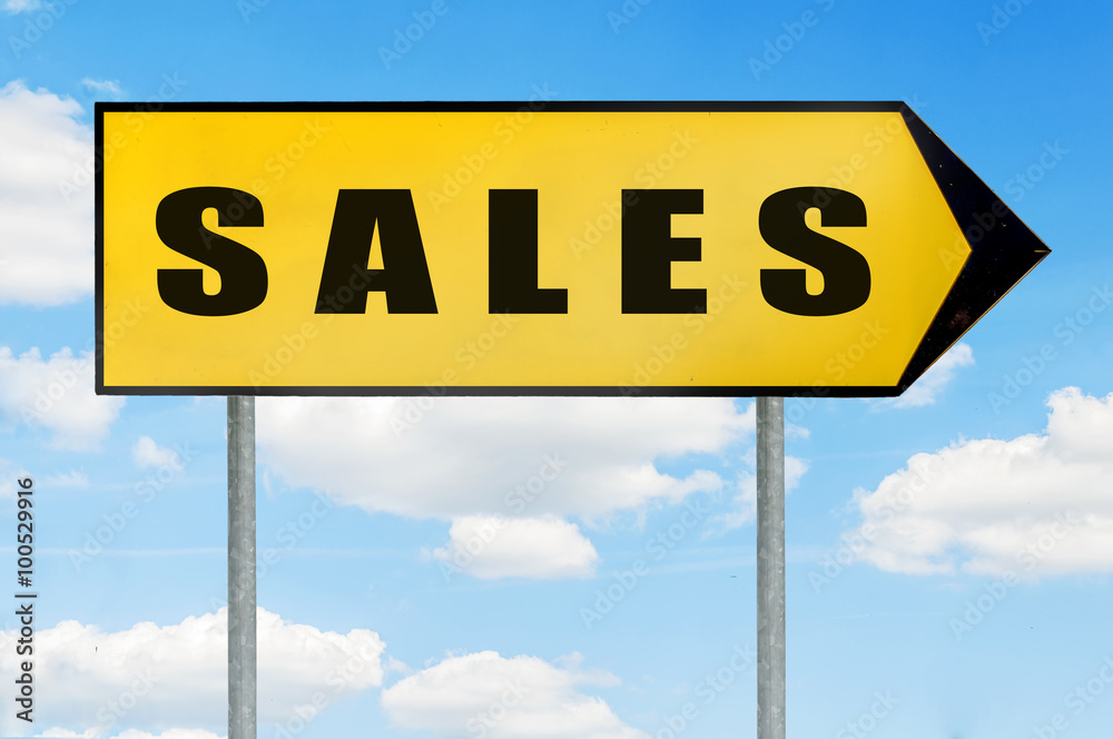 Sales Sign -Yellow road sign with arrow pointing right against blue cloudy sky Sales Sign -Yellow road sign with arrow pointing right against blue cloudy sky
