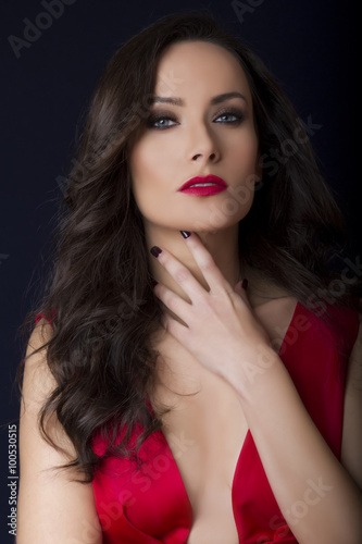 Beautiful sexy brunette with red low cut dress