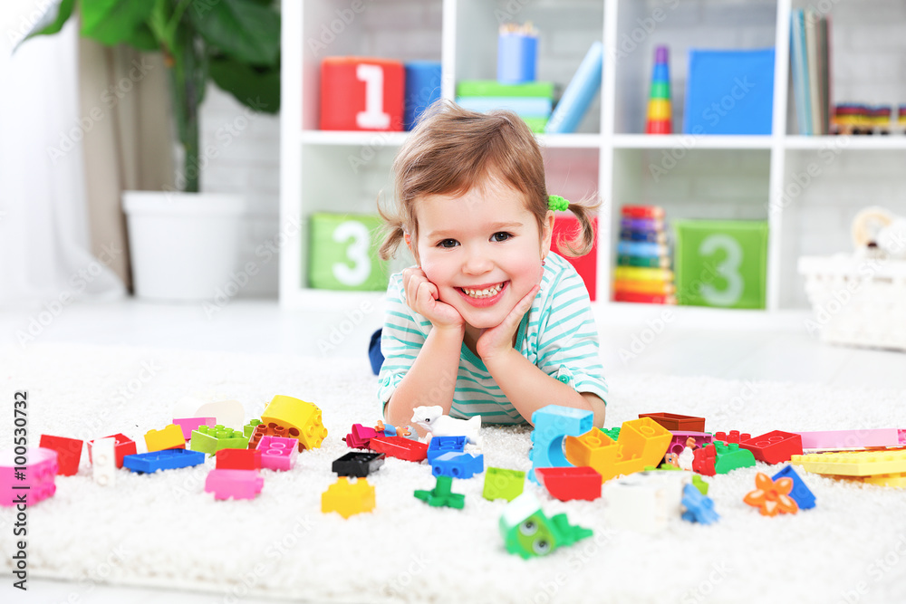 happy child laughing and playing with toys constructor happy child laughing and playing with toys constructor