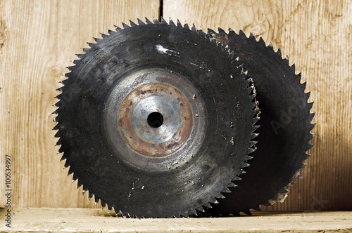 old circular saw blade with wooden background