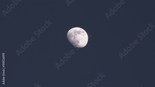Three quarter moon in clear night sky.