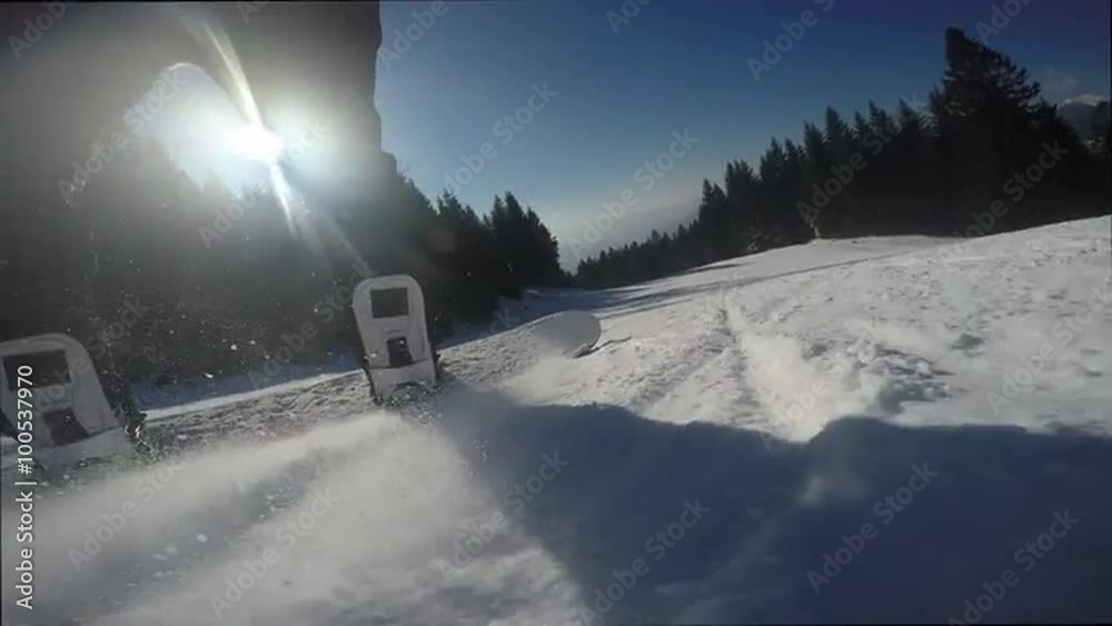 Snowboarding with sun at the background