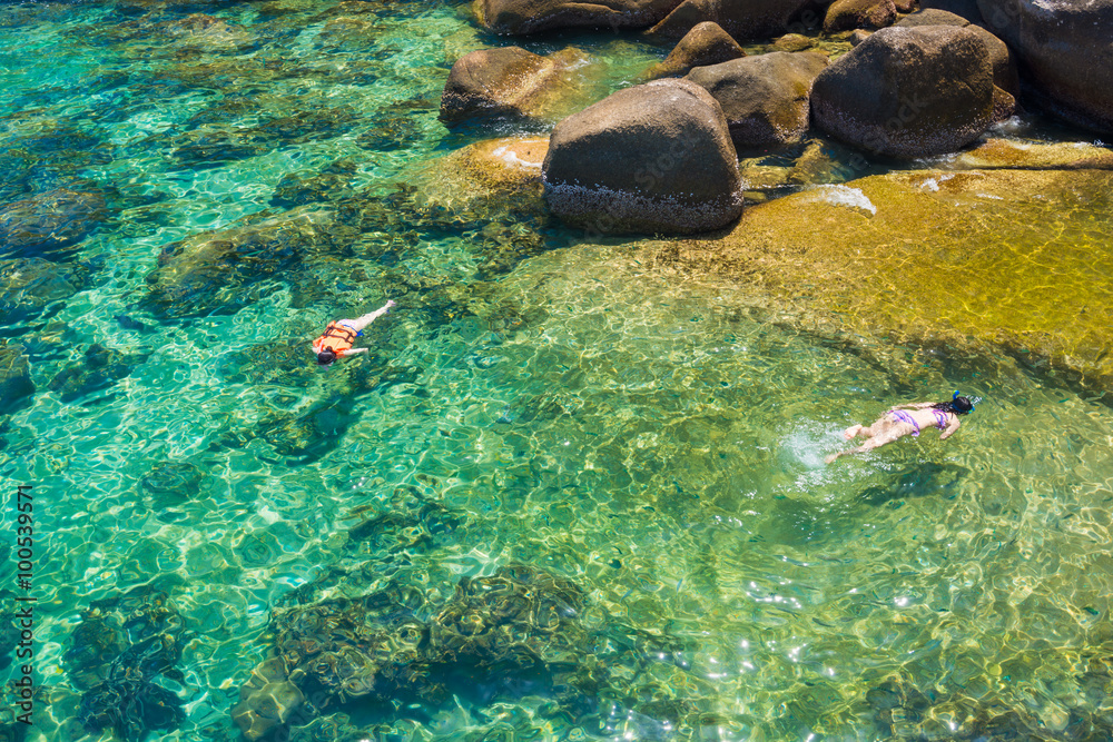 Woman snorkeling in clear sea