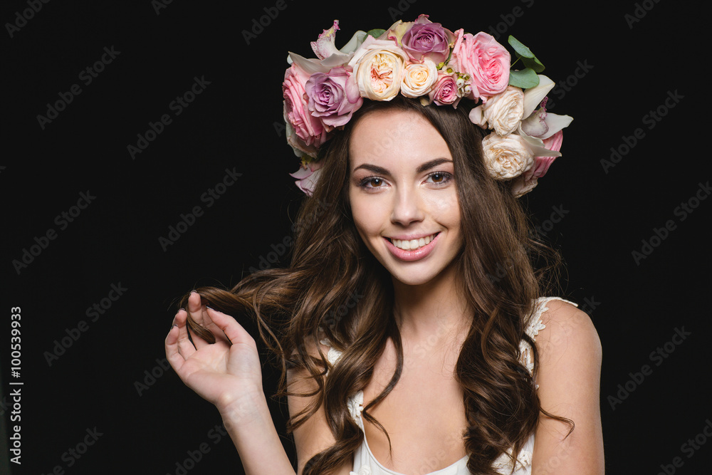 Attractive cheerful woman with beautiful long hair in flower wreath