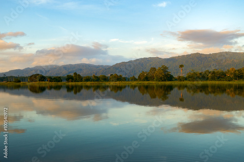 Reflection by the lake with beautiful clouds formation. Nature landscape. © Mohamad Zaki
