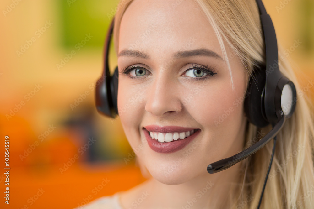 Close-up portrait of a customer service agent sitting at office