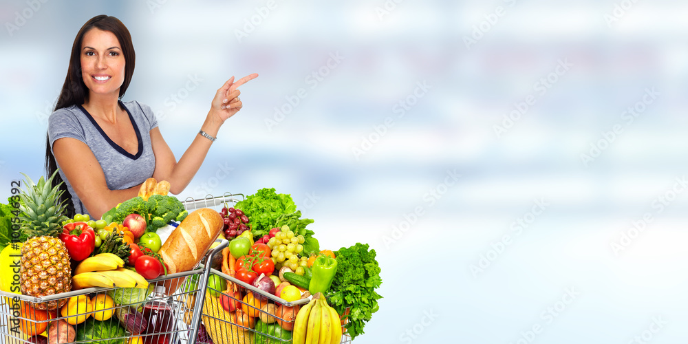 Happy young woman with grocery shopping cart. Happy young woman with grocery shopping cart.