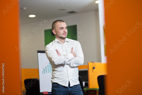 Smiling businessman having mobile phone conversation while stand