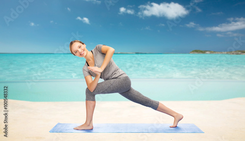 woman making yoga low angle lunge pose on mat © Syda Productions