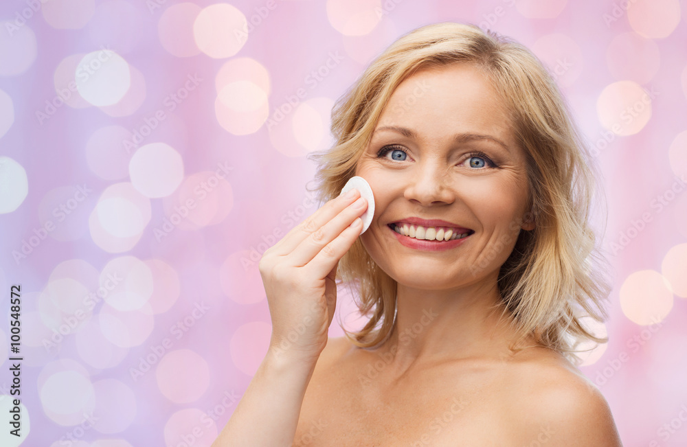 happy woman cleaning face with cotton pad happy woman cleaning face with cotton pad