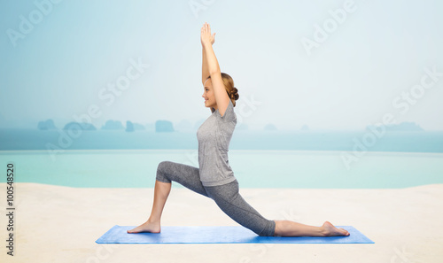 happy woman making yoga in low lunge on mat