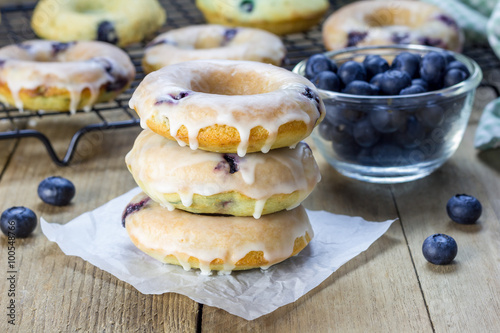 Obraz na płótnie Freshly baked baked doughnuts with blueberries and lemon glaze, for breakfast
