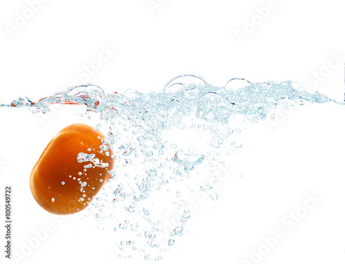 tomato falling or dipping in water with splash