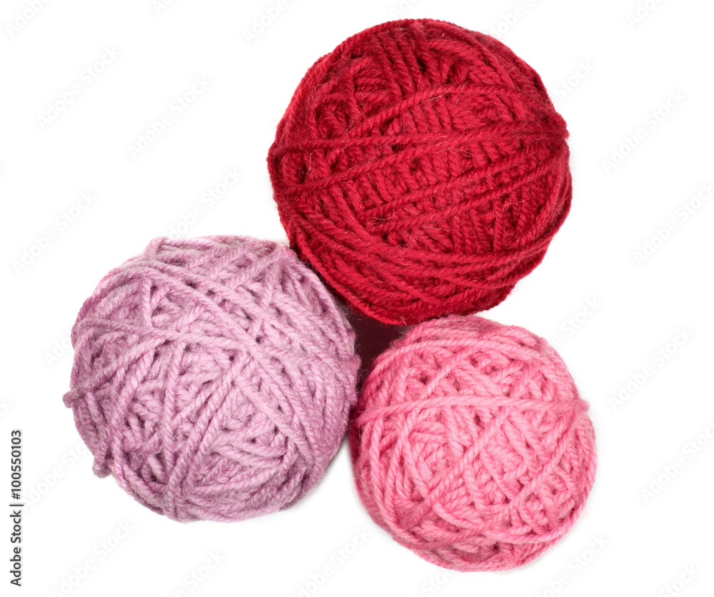 Three skeins in pink and red tones over white Three skeins in pink and red tones over white