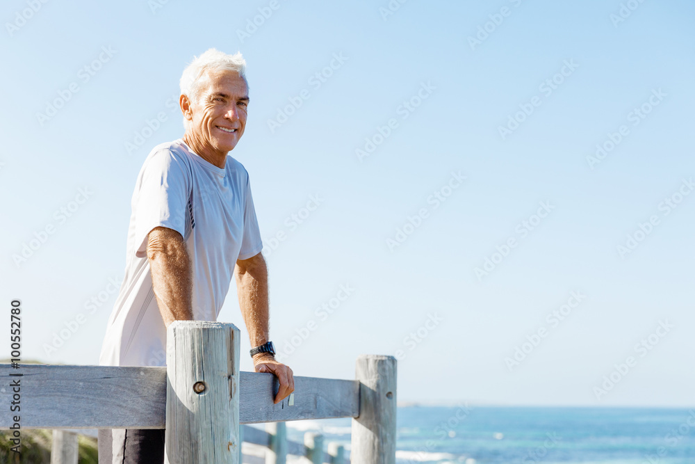 Fototapeta premium Man standing on beach in sports wear