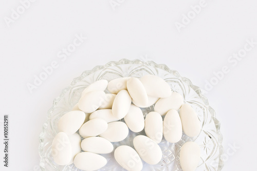 White dragees in a vintage plate