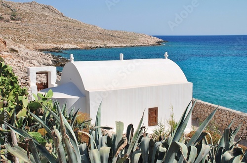 A small seafront chapel by Pondamos beach at Emborio on the Greek island of Halki. photo