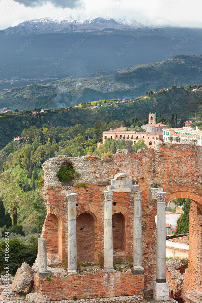 Greek Theater of Taormina and foggy Etna mountain on the background, Sicily, Italy