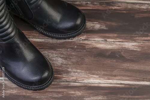 pair of leather boots on wooden surface