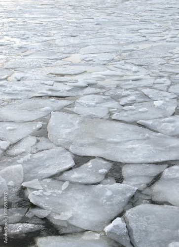 global warming impact on the environment, floating ice on fjord sea water in a freezing cold norwegian winter
