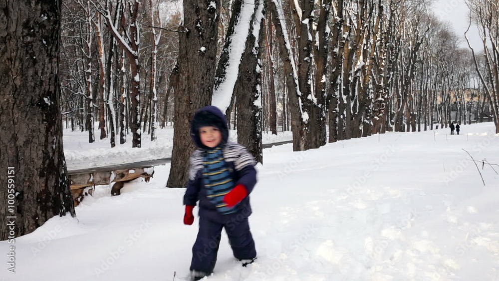Cheerful child playing in the snow Cheerful child playing in the snow
