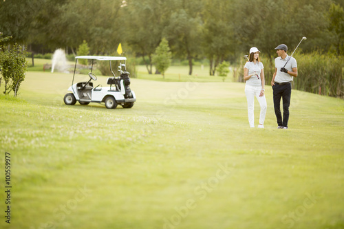 Young couple at golf cart