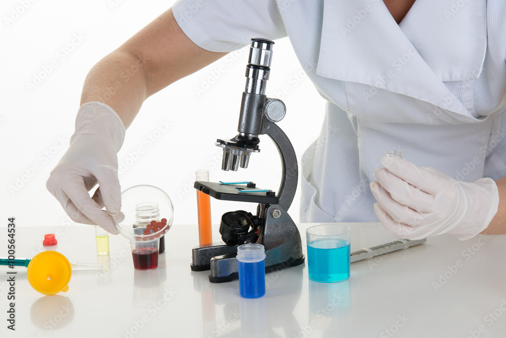 Scientist with microscope making research in clinical laboratory Scientist with microscope making research in clinical laboratory