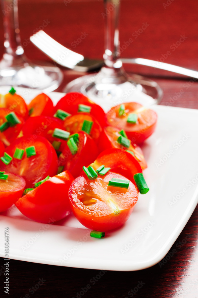 Cherry tomatoes decorated with green onions. Cherry tomatoes decorated with green onions.