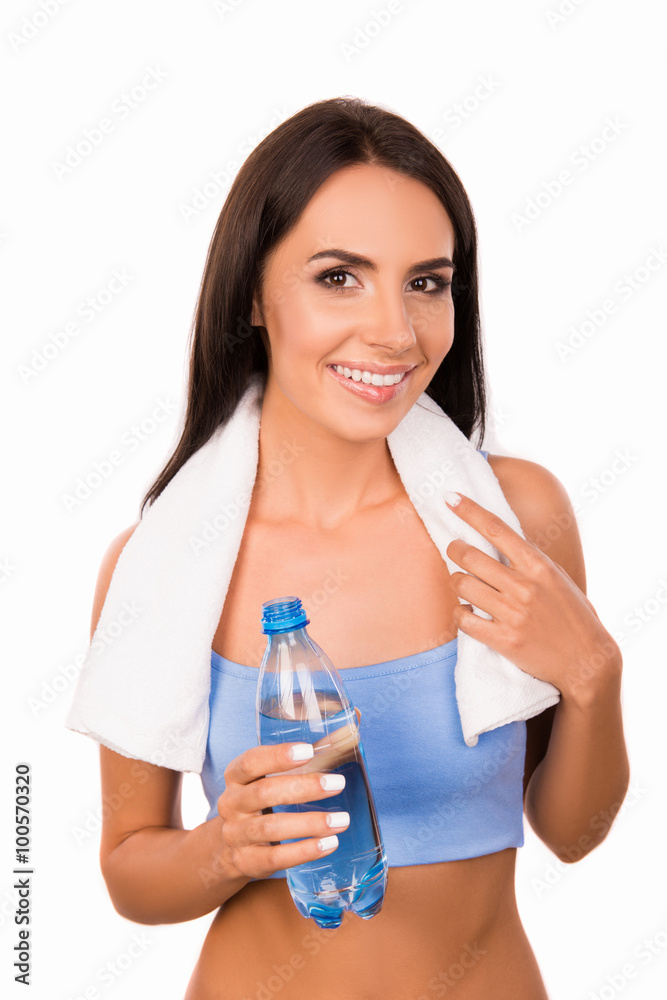 Slender girl with towel holding a bottle with water Slender girl with towel holding a bottle with water