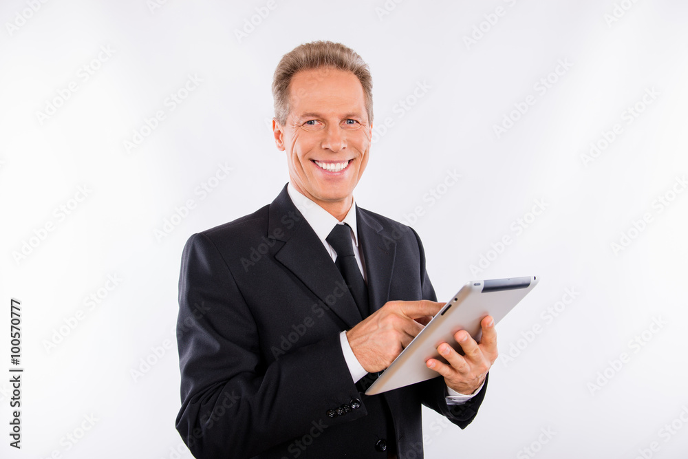 A mature happy manager reading news in his laptop A mature happy manager reading news in his laptop