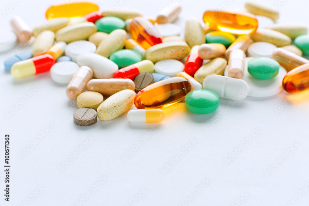 Vitamins, omega 3, cod-liver oil, dietary supplement and tablets an embankment on a light background close up, the top view