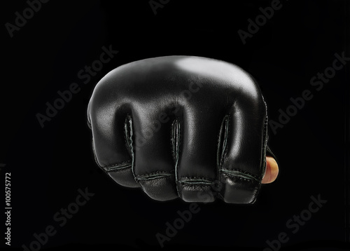 fist black gloves for martial arts , mma on a black background.