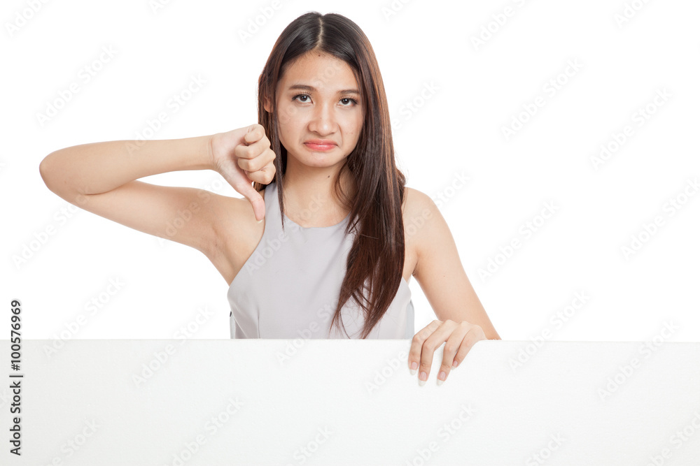Unhappy young Asian woman thumbs down with blank sign Unhappy young Asian woman thumbs down with blank sign