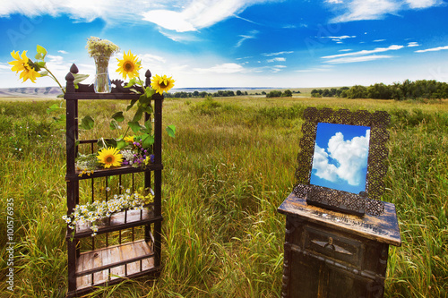 Beautiful rural landscape of field with vintage furniture  photo