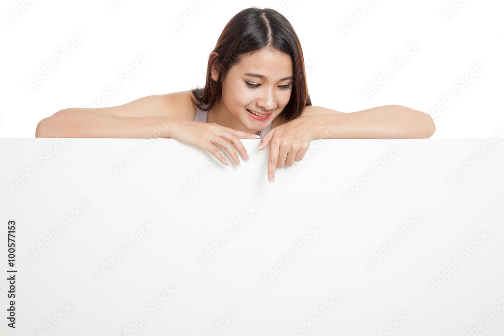 Young Asian woman point down behind a blank sign Young Asian woman point down behind a blank sign