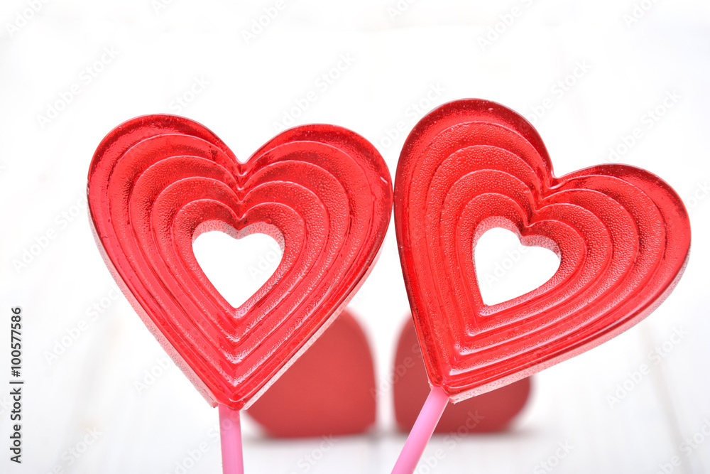 Lollipops in the shape of the heart on the white background 