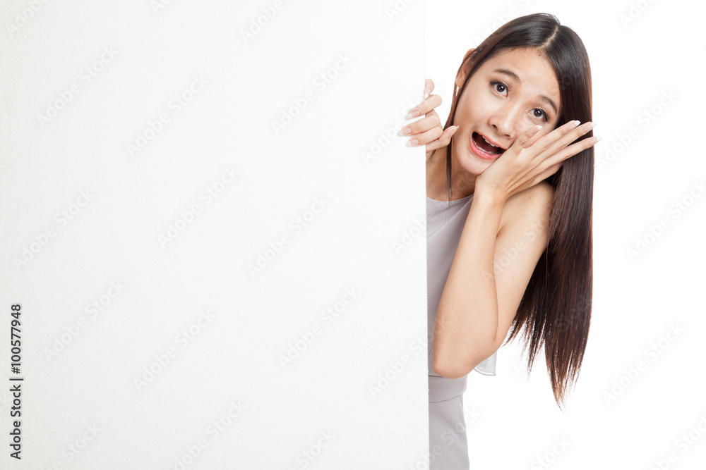 Excited young Asian woman behind blank sign Excited young Asian woman behind blank sign