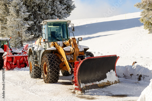 large tractor with snow plow during a winter