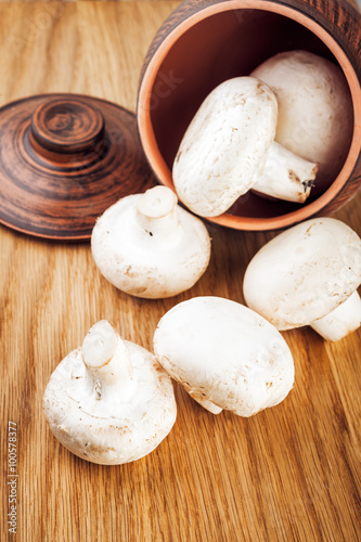 Fresh mushrooms on a ceramic pot.