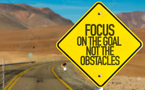 Focus On The Goal Not The Obstacles sign on desert road