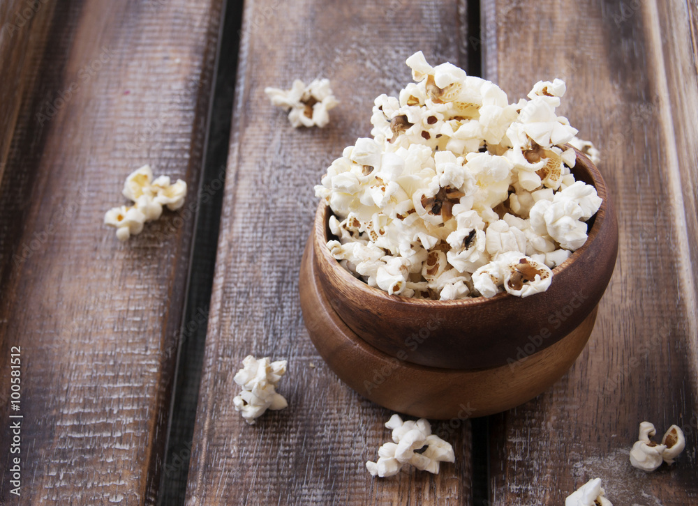  bowl of popcorn on a brown wooden table