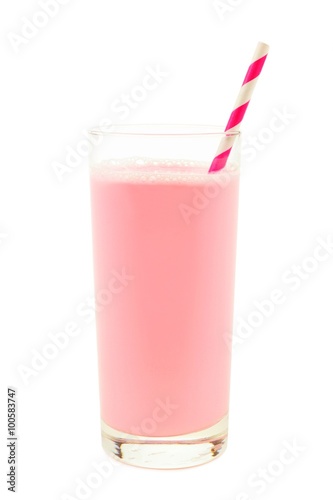 Strawberry milk in a glass with striped paper straw isolated on a white background