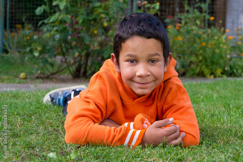 Cute boy gypsy race smiling in grass Stock Photo | Adobe Stock