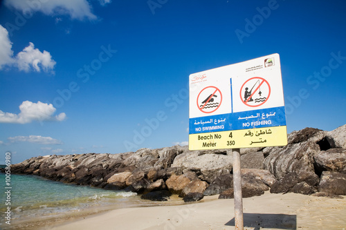 Stand with the rules of conduct on the beach